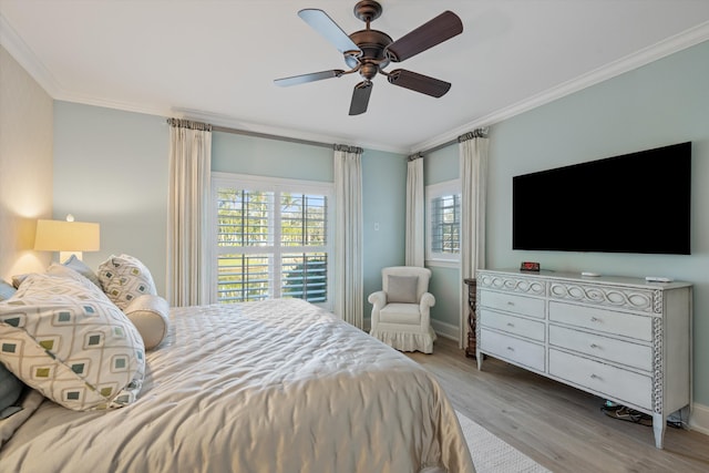 bedroom with ornamental molding, light hardwood / wood-style floors, and ceiling fan