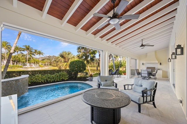 view of pool featuring pool water feature, ceiling fan, an outdoor living space, and a patio area