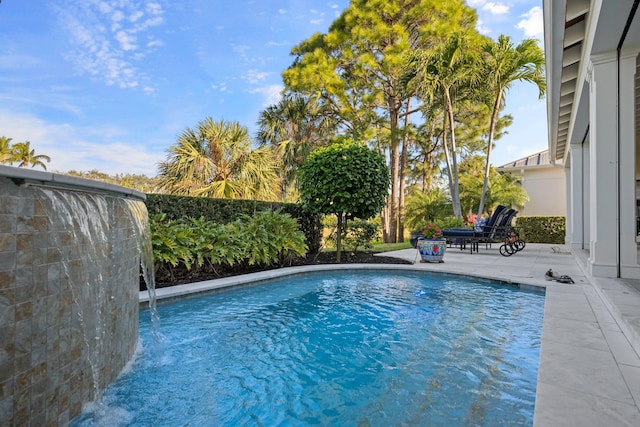 view of pool featuring a patio and pool water feature