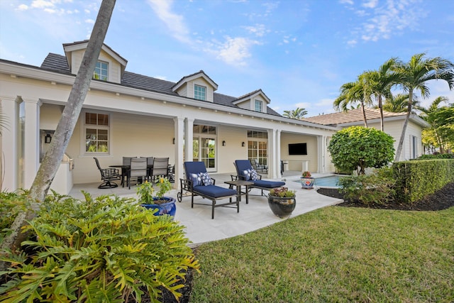 rear view of house featuring a yard and a patio area