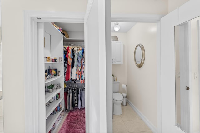 bathroom with toilet and tile patterned flooring