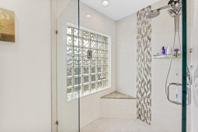 bathroom with a shower with door