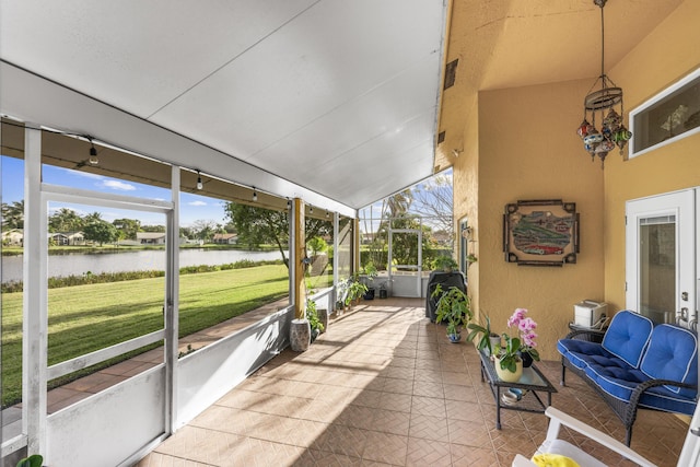 sunroom with a water view and vaulted ceiling