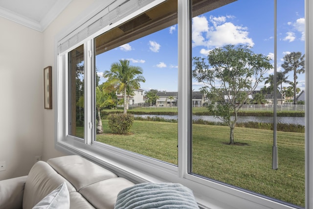 sunroom featuring a water view