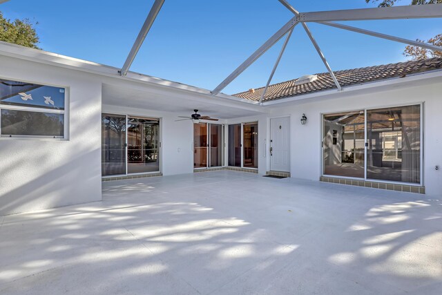 view of patio featuring a lanai and ceiling fan