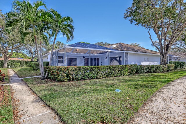 ranch-style home with a lanai and a front yard