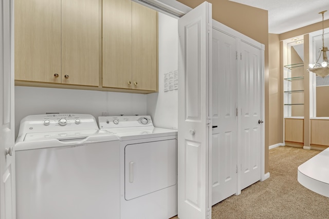 washroom with washer and dryer, light colored carpet, and cabinets