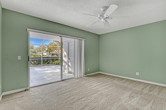 spare room with a textured ceiling, ceiling fan, and carpet flooring