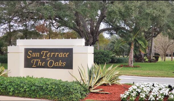 community / neighborhood sign with a yard