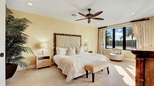 bedroom featuring baseboards, visible vents, ceiling fan, and light colored carpet