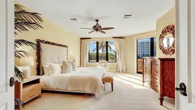 bedroom with baseboards, visible vents, a ceiling fan, and light colored carpet