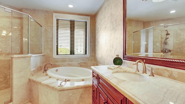 bathroom featuring a stall shower, a garden tub, vanity, and recessed lighting