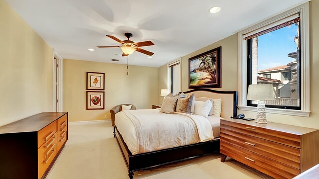 bedroom with baseboards, recessed lighting, visible vents, and light colored carpet