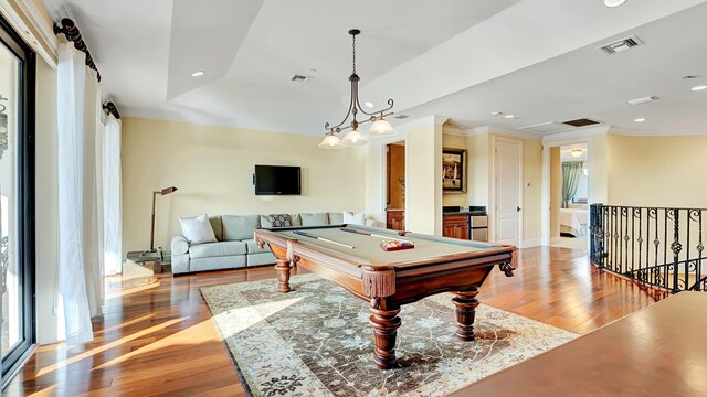 game room featuring crown molding, visible vents, and light wood-style floors