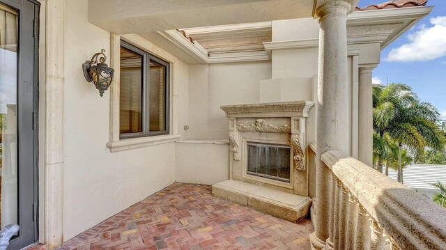 entrance to property with a tiled roof and stucco siding