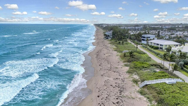 bird's eye view with a water view and a view of the beach