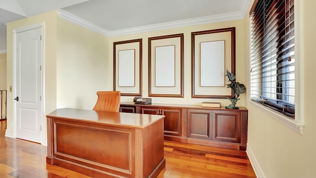 unfurnished office featuring ornamental molding, light wood-type flooring, and baseboards