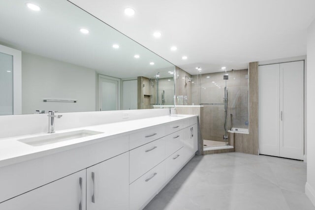 bathroom featuring vanity and an enclosed shower