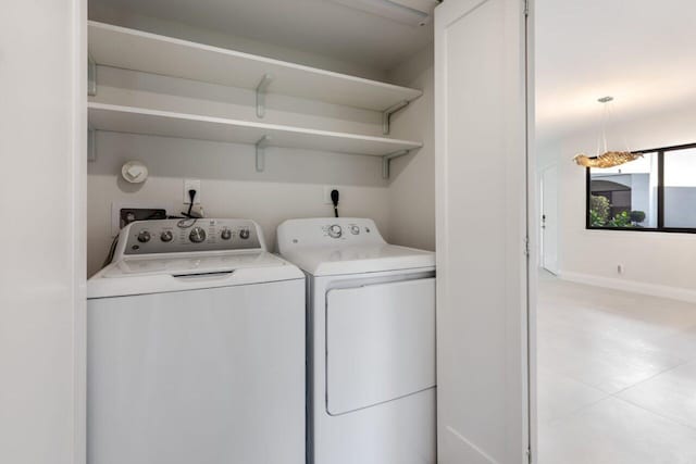 clothes washing area featuring separate washer and dryer