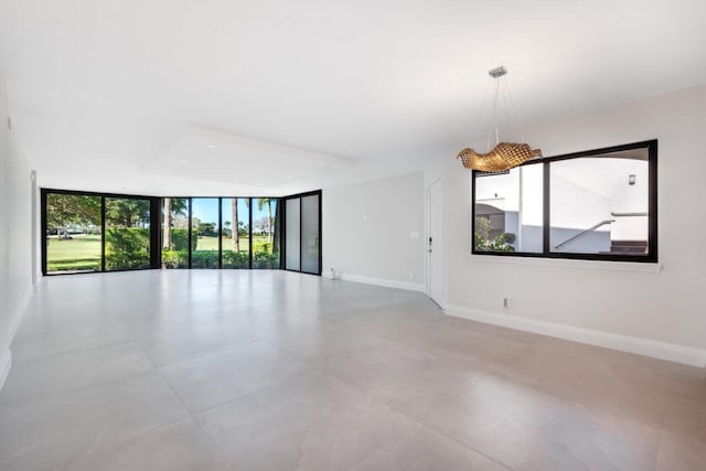 spare room with plenty of natural light and floor to ceiling windows