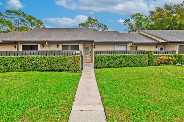 ranch-style house with a front lawn