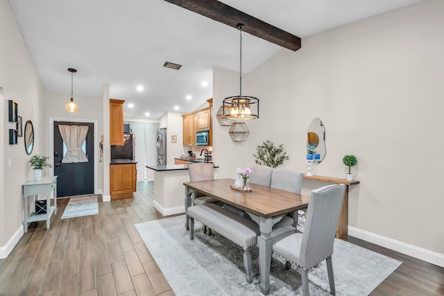 dining room with lofted ceiling with beams