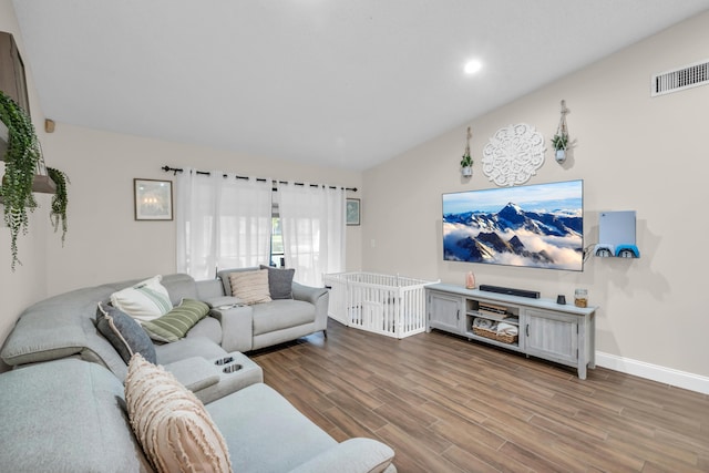 living room featuring hardwood / wood-style floors and lofted ceiling