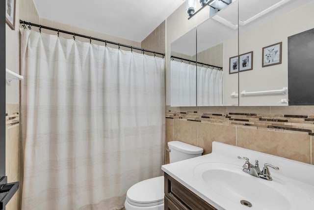 bathroom featuring vanity, toilet, tile walls, and backsplash