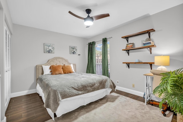 bedroom with dark wood-type flooring, a closet, and ceiling fan