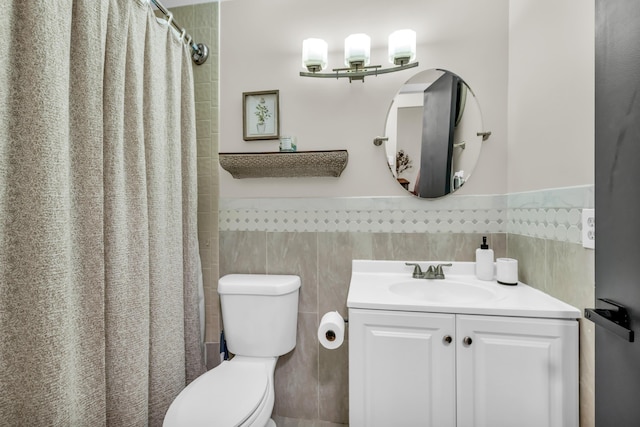 bathroom featuring tile walls, toilet, vanity, and a shower with shower curtain