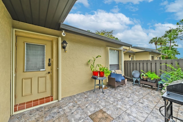 view of exterior entry featuring a patio