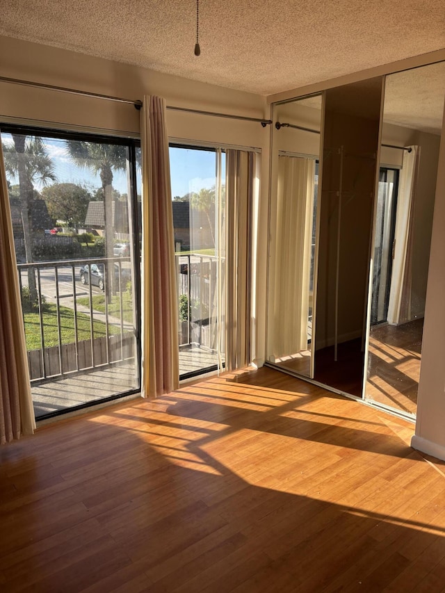 doorway featuring hardwood / wood-style floors and a textured ceiling