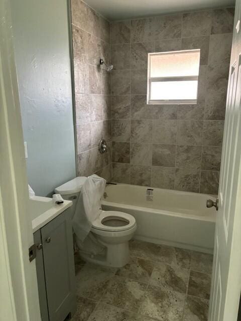 full bathroom with vanity, toilet, and tiled shower / bath combo