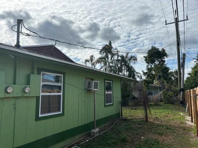 view of property exterior featuring a wall mounted air conditioner