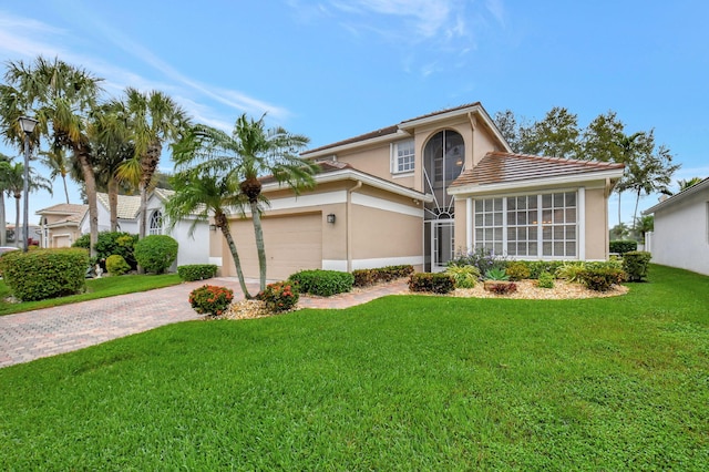 view of front of house featuring a front yard and a garage