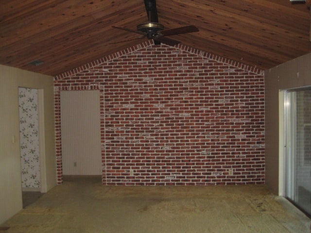 interior space with brick wall, carpet, ceiling fan, and vaulted ceiling