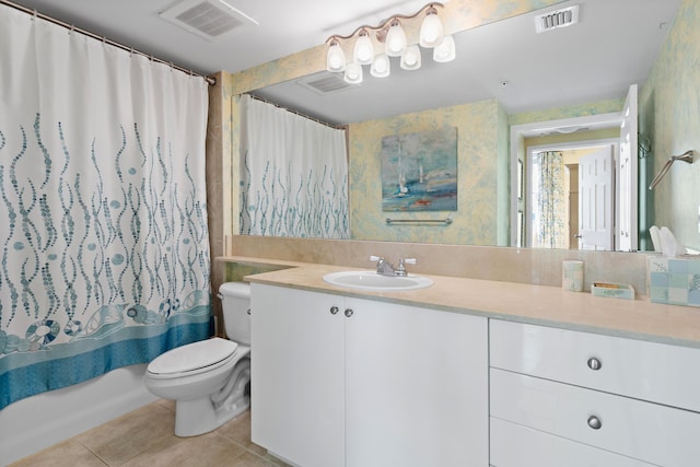 full bathroom featuring tile patterned flooring, vanity, shower / bath combo with shower curtain, and toilet