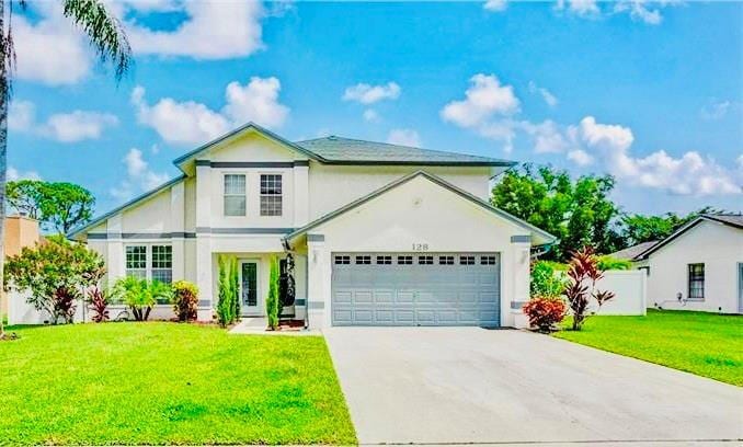 front of property featuring a front lawn and a garage