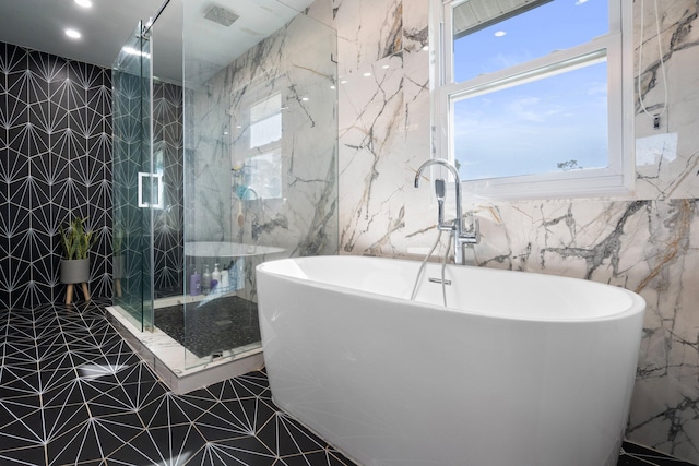 bathroom featuring independent shower and bath and tile walls