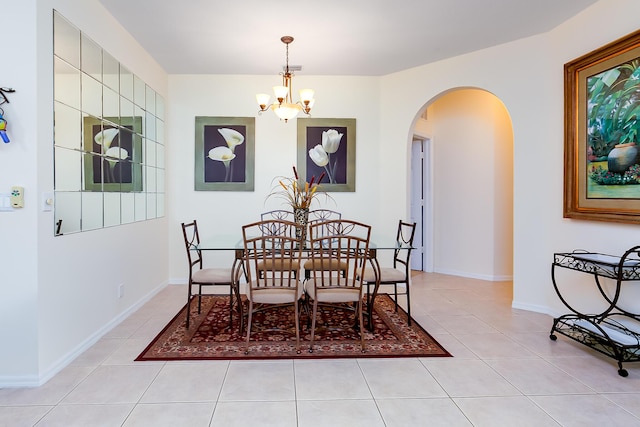 dining space featuring a notable chandelier and light tile patterned flooring