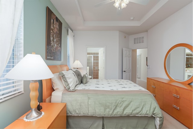 306 SW Tomoka Springs Dr, Port Saint Lucie, FL 34986 - bedroom with a tray ceiling, ceiling fan, visible vents, and ensuite bathroom
