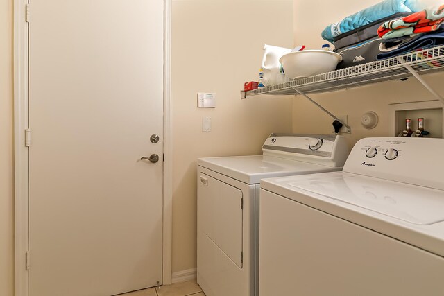 306 SW Tomoka Springs Dr, Port Saint Lucie, FL 34986 - washroom featuring washing machine and dryer, laundry area, and light tile patterned flooring