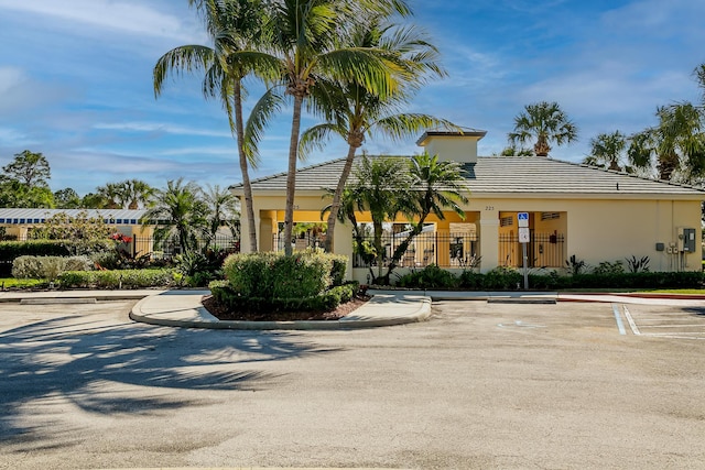 306 SW Tomoka Springs Dr, Port Saint Lucie, FL 34986 - view of building exterior featuring uncovered parking and fence