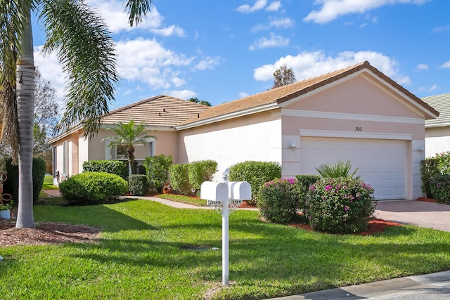 306 SW Tomoka Springs Dr, Port Saint Lucie, FL 34986 - view of side of home featuring a tiled roof, a yard, stucco siding, an attached garage, and driveway
