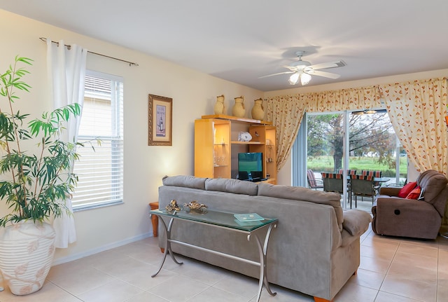 living room with light tile patterned floors, plenty of natural light, and ceiling fan