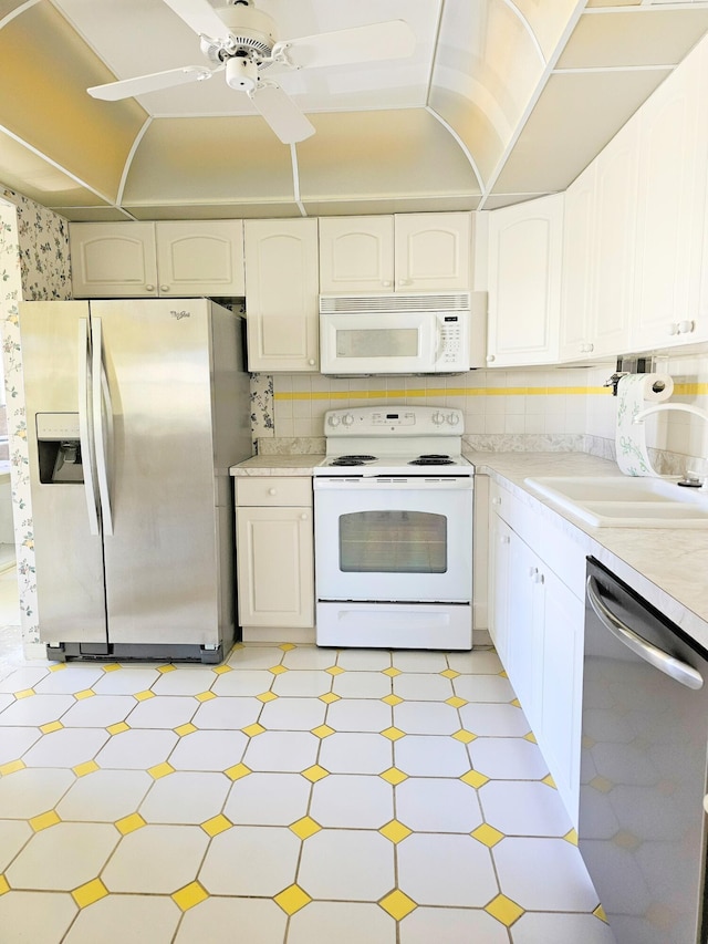 kitchen with white cabinetry, appliances with stainless steel finishes, and light countertops