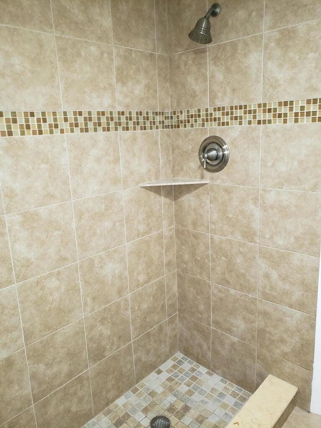 bathroom with a tile shower