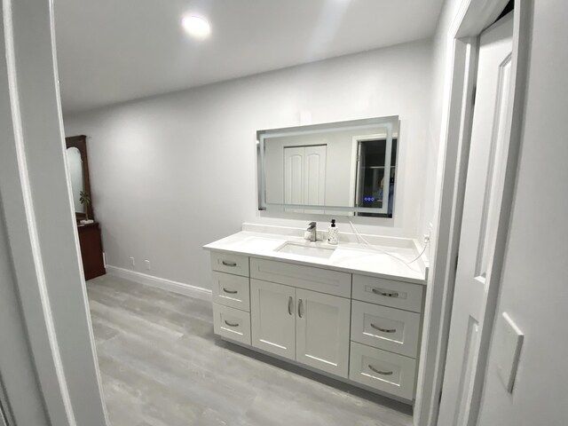 bathroom with vanity and hardwood / wood-style floors