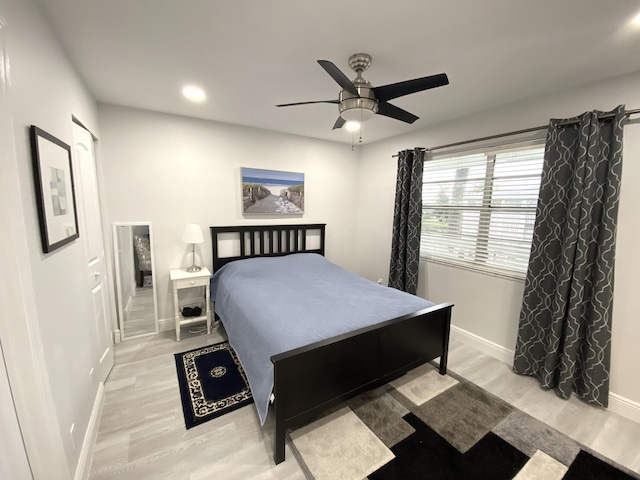 bedroom with ceiling fan and light hardwood / wood-style flooring