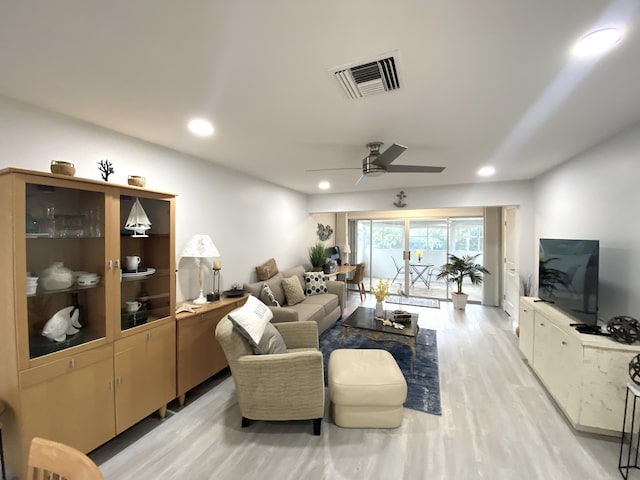 living room featuring ceiling fan and light hardwood / wood-style floors